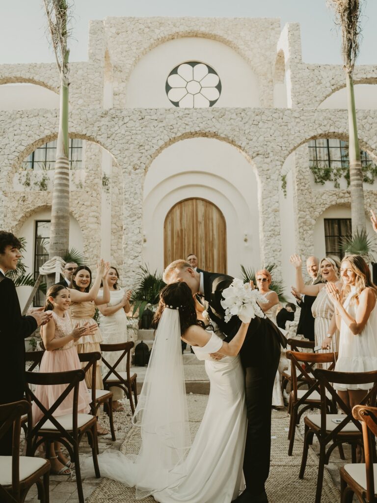 Bride and groom kissing during a luxury wedding ceremony at Casa Arka in Tulum.
